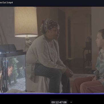 Two people having a serious conversation in a dimly lit room.
