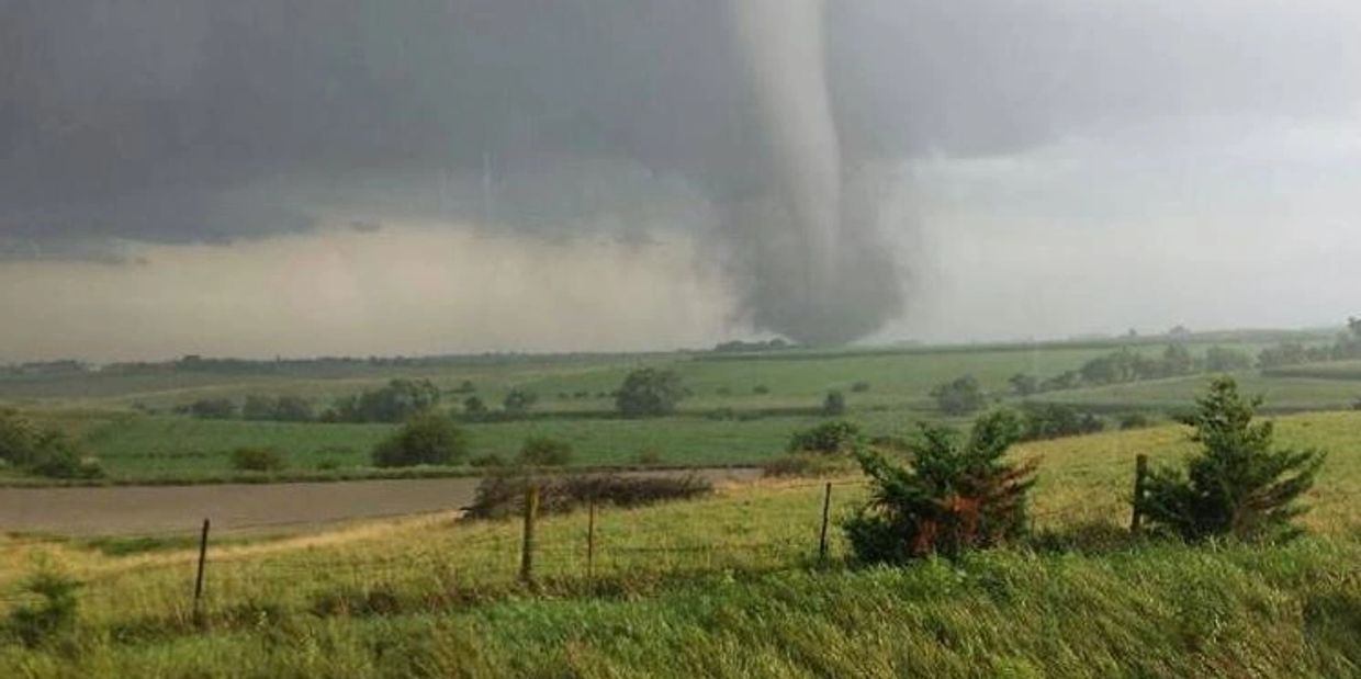 image of tornado going across through pastures