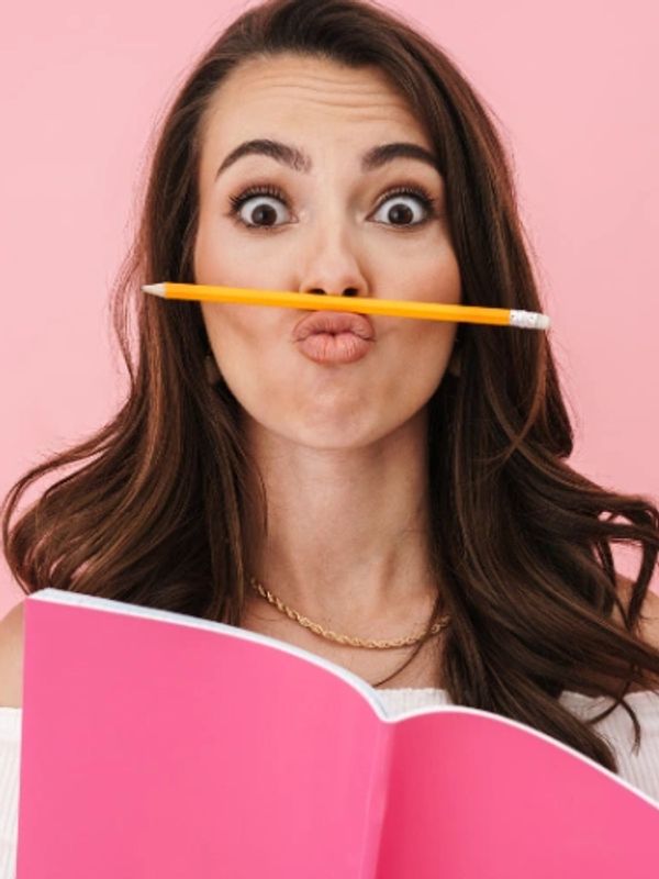 Funny girl studying with pencil above lip.