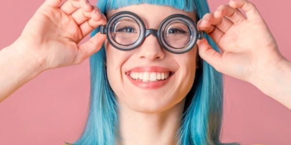 Girl with bright blue hair and silly glasses.