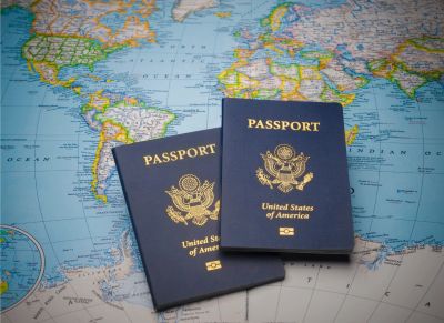 Two US passports on a world map.