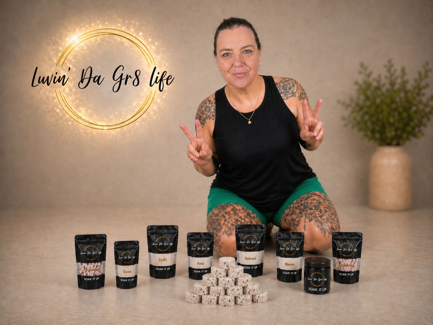 Woman showcasing Luvin' Da Gr8 Life Soak It Up products with peace signs.