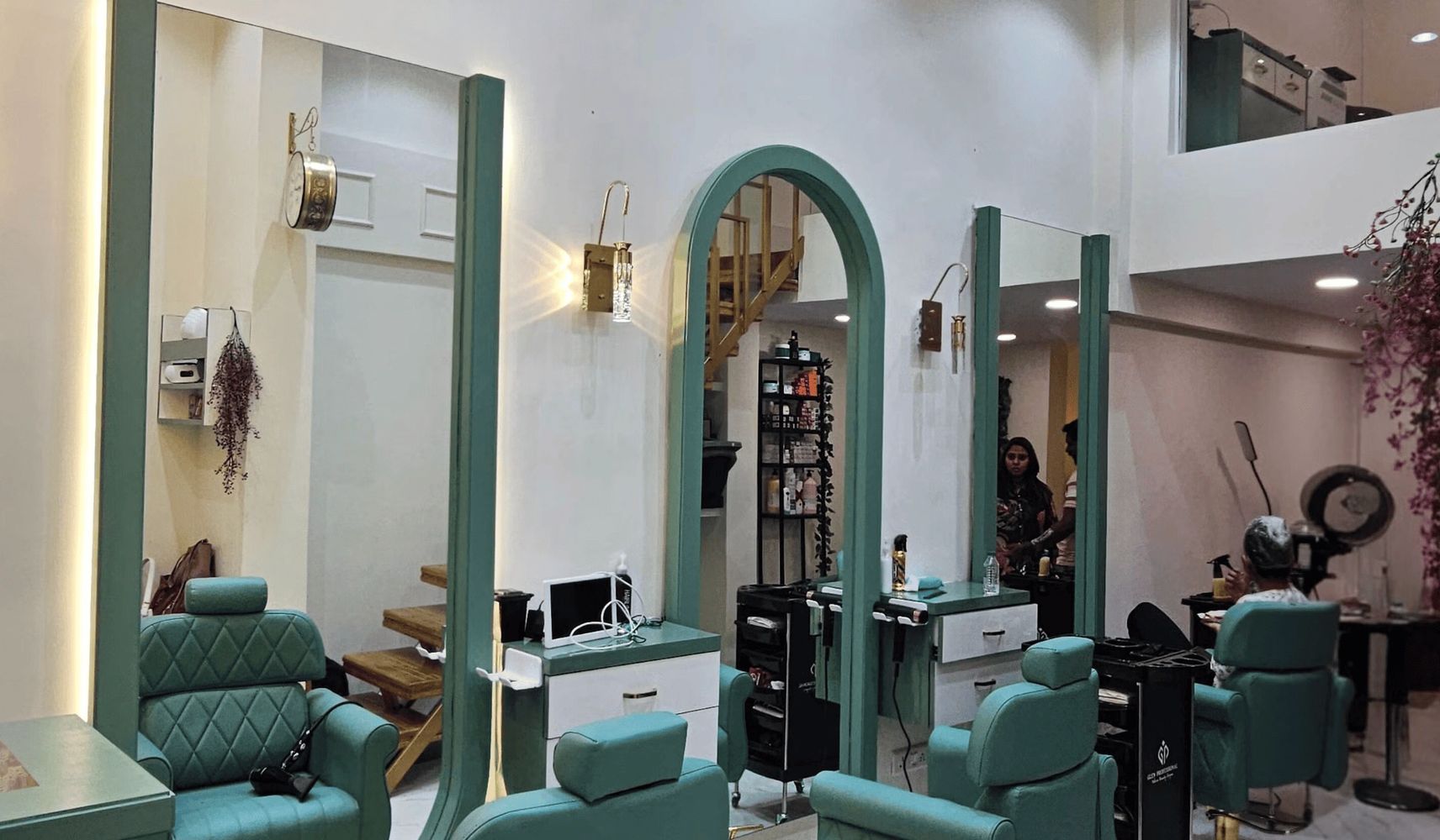 Modern interior of Elara Family Salon Dombivli with teal chairs, large mirrors, and hygienic, comfortable unisex salon setup