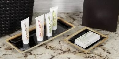 Bathroom toiletries on a marble countertop.