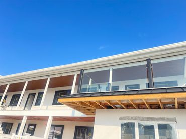 Modern building under construction with clear blue sky.