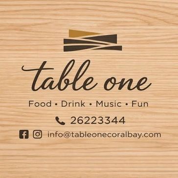 Table One logo with contact and social media details on wooden background.