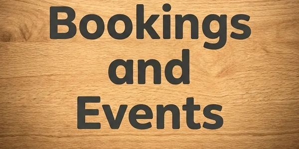 Wooden sign with 'Bookings and Events' text in black letters.