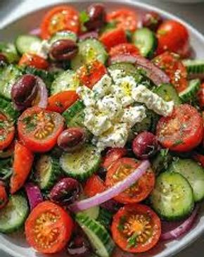 Fresh Greek salad with tomatoes, cucumbers, olives, onions, and feta cheese.
