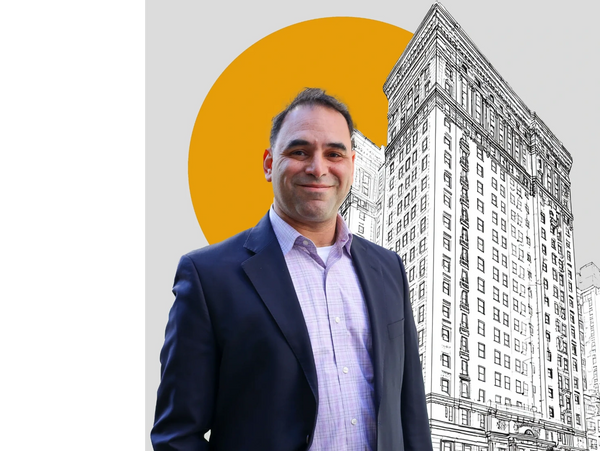 A man in a suit stands in front of a sketched tall building with an orange circle background.