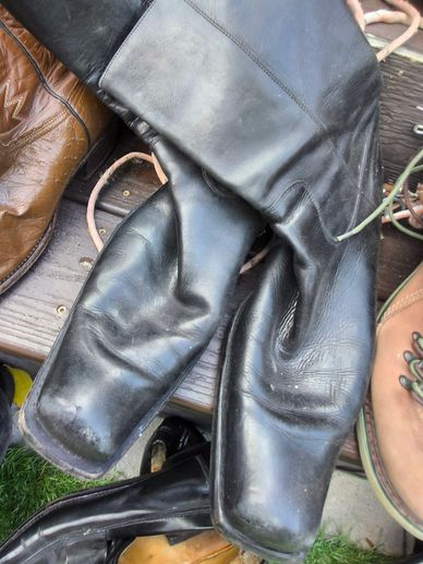 Worn-out black leather boots.