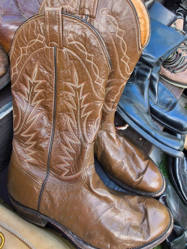 Pair of brown cowboy boots with intricate stitching.