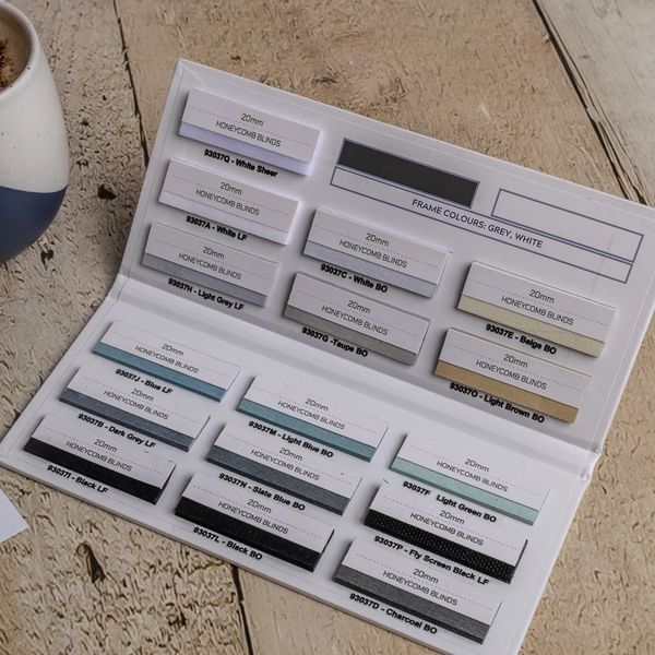 Sample card showing various 20mm honeycomb blind fabric swatches.