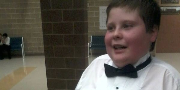 Owners autistic son dressed up for a choir concert.