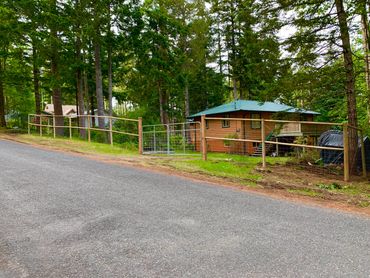 Double rail front deer fence with double gate on 6x6 cemtented in posts.