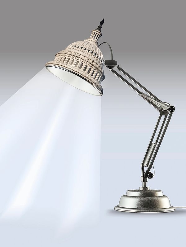 A desk lamp with the Capitol dome as its shade, casting light.