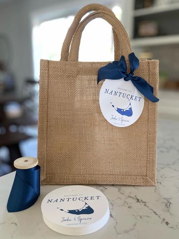 wedding welcome bags with custom tag and a navy blue bow