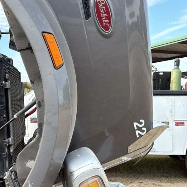 Roadside diesel repair on semi truck with service truck in background