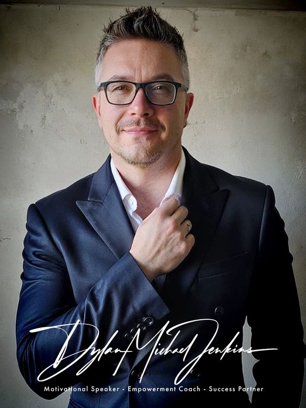 Dylan Jenkins posing for a professional headshot wearing a suit