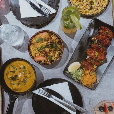 A White Color Table With Dishes and Pans of Food