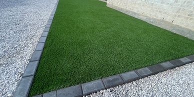 artificial grass, concrete, hardscape, fence, fire pits, outdoor kitchen, pavers, rock, travertine