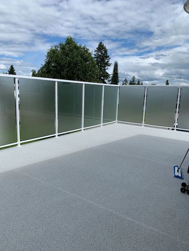 A Deck Space With Glass Panels as Railing