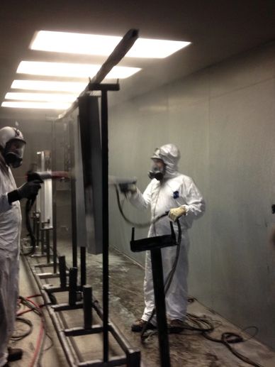 Two Men Fixing Glass Panels in a Railing