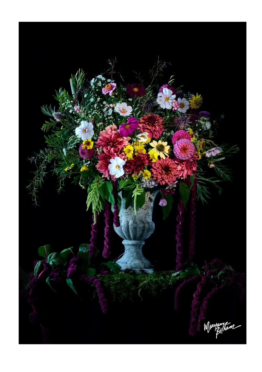 A vibrant floral arrangement in a rustic vase against a black background.