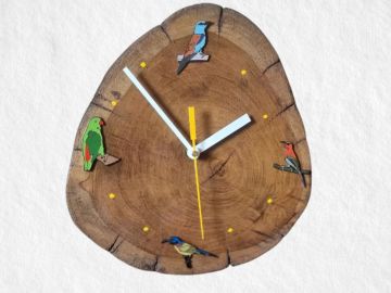 Wooden clock with bird decorations.