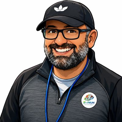 Smiling man wearing glasses, a cap, and a dark jacket with a S-PAM badge.