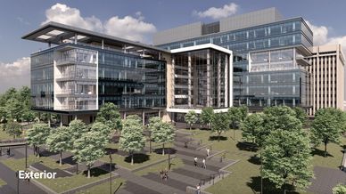 Modern office building surrounded by trees and walkways.