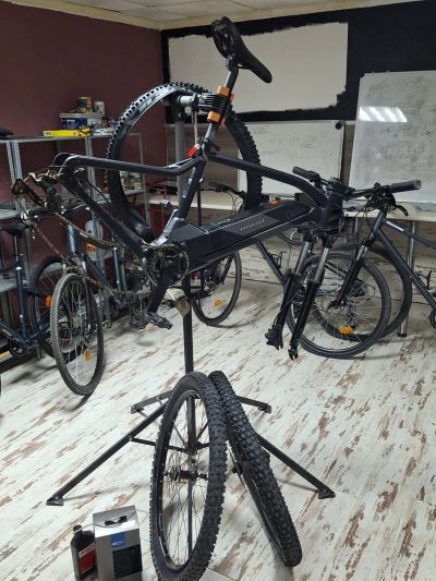 Bicycle undergoing maintenance in a workshop.