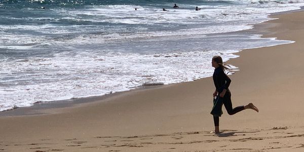 A Girl running at the shore