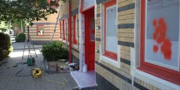 Commercial building painting, sprayed red window frames 