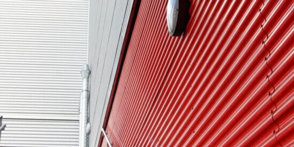 Commercial cladding spray painted red warehouse 