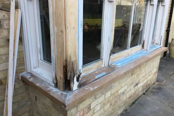Before image of a casement window with rotten wood
