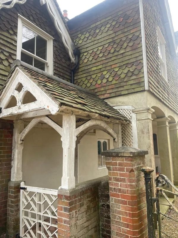 Before photo of a period property entrance with rotten wooden porch
