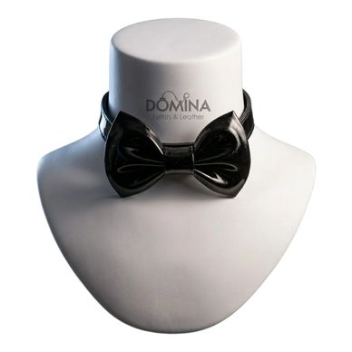 Black leather bow tie displayed on a white mannequin bust.