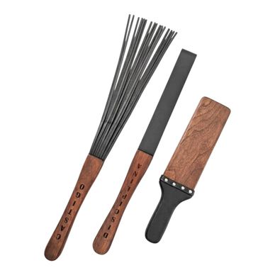 Three wooden-handled spanking paddles and whips.