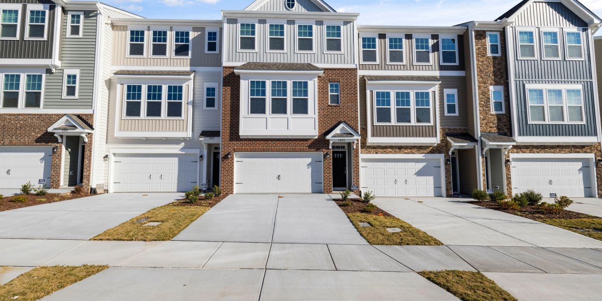 Row of modern townhouses with garages.
