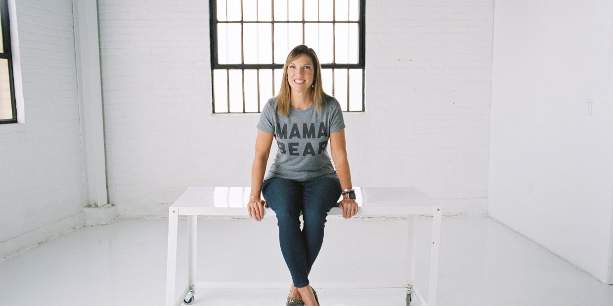 A photo of Betsy Furler in a tshirt that says Mama Bear and jeans. Photo by Katy Schilhab Photograph