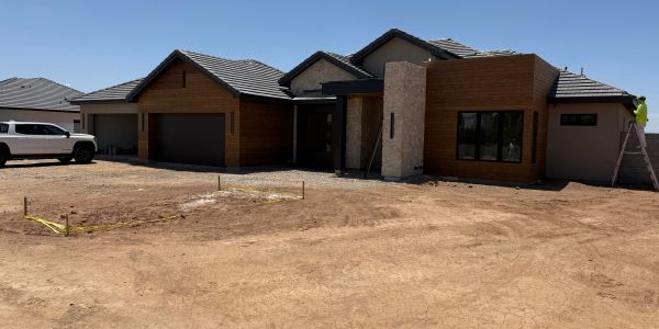 New construction house with wooden accents and stone features.
