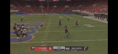 Video game football kickoff with a score of 65-0.