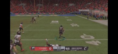 Video game football match with one team leading 65-0.