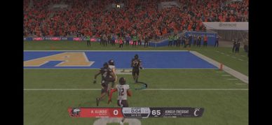 College football game with Cincinnati leading against Arkansas 65-0.