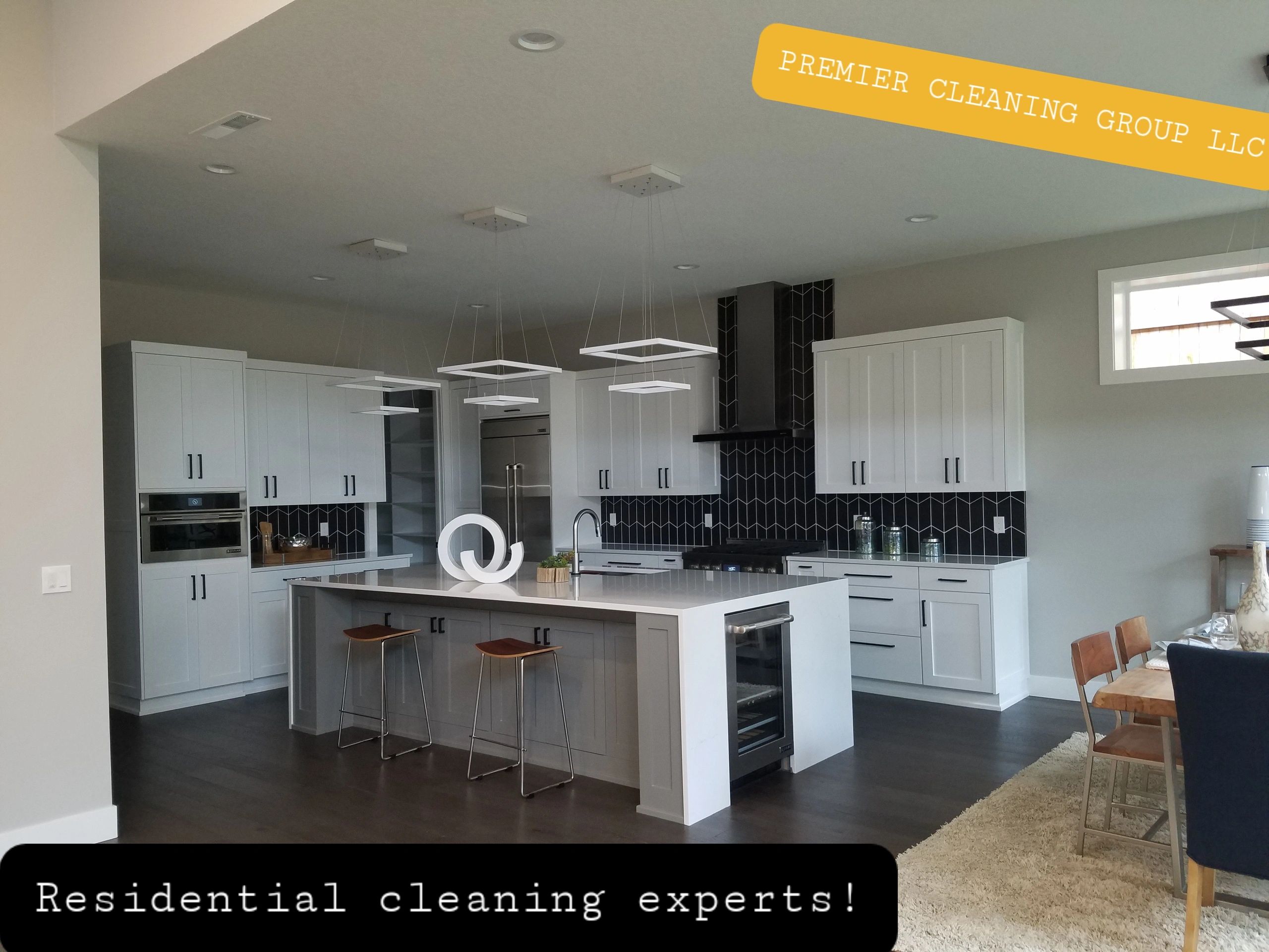 Modern clean kitchen with island and stools.