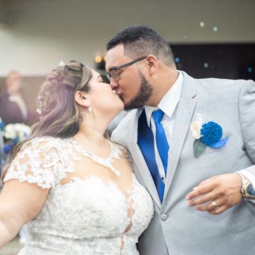 Professional wedding photography of newlyweds kissing at their wedding photo
