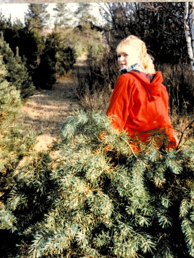 Owner, Cathy, helping her Parents Harvest Trees for their retail lots in 1985.