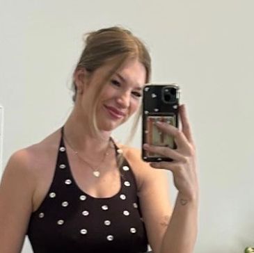 Young woman taking a mirror selfie with a smartphone.