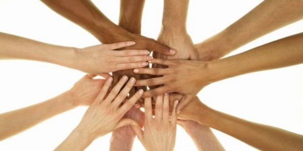 diverse hands meeting in the middle - in a go team kind of way