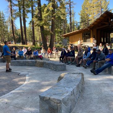 People sitting in the amphitheater at Spooner Lake State Park.